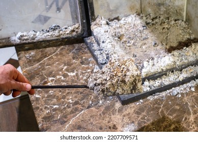 Cleaning The Fireplace. Ash And Charred Piece Of Wood Lying On The Blade With A Long Handle Closeup