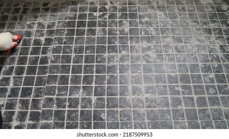 Cleaning Floor Tiles From Grout Residue. Close-up Of A Professional Cleaner Cleaning Solution On A Tiled Floor In A Bathroom.