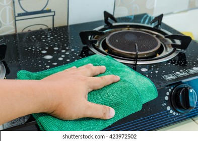 Cleaning The Gas Stove In Kitchen