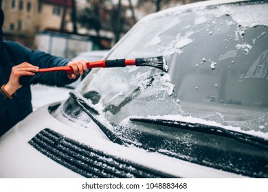 Cleaning The Glass Machine From Snow And Ice Brushing.