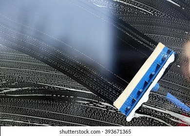 Cleaning A Glass With Squeegee Close Up