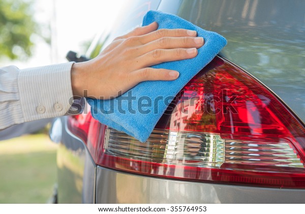 Cleaning\
headlight with microfiber cloth,car\
lights