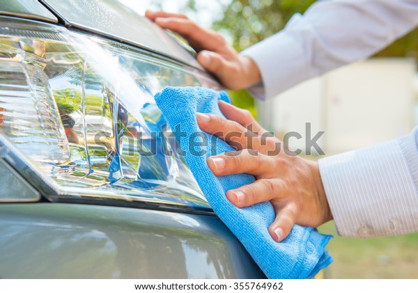 Cleaning\
headlight with microfiber cloth,car\
lights