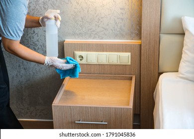 Cleaning In Hotel Or Hospital. Hands In Gloves Cleaning And Disinfecting Elevator Buttons And Doors Using Alcohol Sanitizer Spray. Back View. Disinfection, Cleanliness. Housekeeper In Hotel Hall