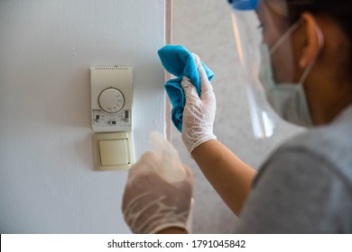 Cleaning In Hotel Or Hospital. Hands In Gloves Cleaning And Disinfecting Elevator Buttons And Doors Using Alcohol Sanitizer Spray. Back View. Disinfection, Cleanliness. Housekeeper In Hotel Hall