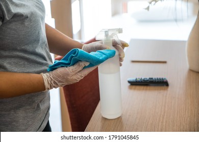 Cleaning In Hotel Or Hospital. Hands In Gloves Cleaning And Disinfecting Elevator Buttons And Doors Using Alcohol Sanitizer Spray. Back View. Disinfection, Cleanliness. Housekeeper In Hotel Hall