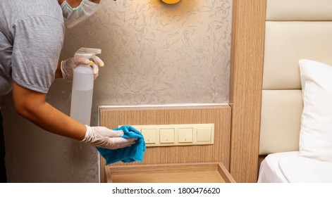 Cleaning In Hotel Or Hospital. Hands In Gloves Cleaning And Disinfecting Elevator Buttons And Doors Using Alcohol Sanitizer Spray. Back View. Disinfection, Cleanliness. Housekeeper In Hotel Hall