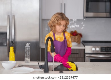 Cleaning house. Little housekeeper. Child washing and wiping dishes in kitchen. American kid learning domestic chores at home. Kid cleaning to help parents with housework routine.