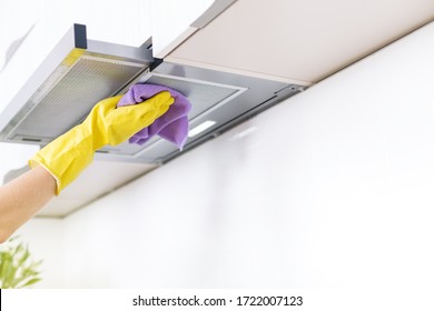 Cleaning the house. Washing kitchen hood, hand in glove clean aluminium filters. Clear extractor without fat. - Shutterstock ID 1722007123