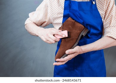 Cleaning Ideas. Professional Male Shoes Cleaner with Brush For Suede Derby Boots Cleaning While Working in Workshop. Horizontal Image - Powered by Shutterstock