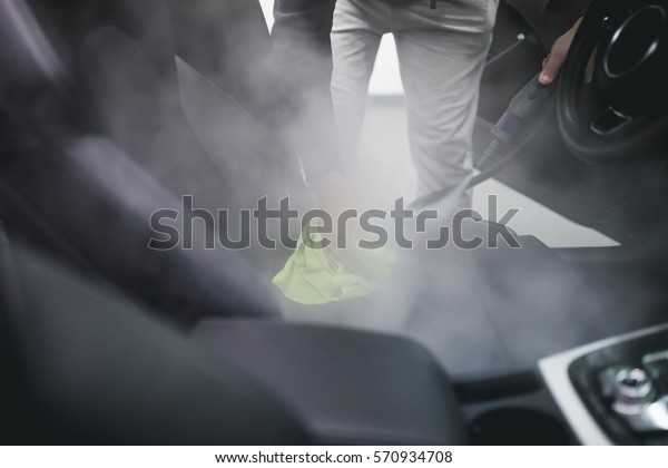 Cleaning interior of the car with hot steam.\
Selective focus.