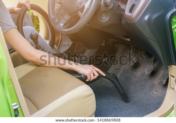 Cleaning of interior of the car with vacuum cleaner,\
Cleaning in car