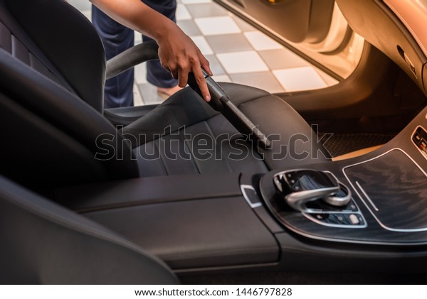 Cleaning of interior of the car with vacuum\
cleaner, Car cleaning