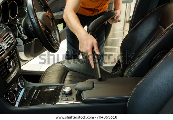 Cleaning of interior of the car with vacuum\
cleaner, Car cleaning