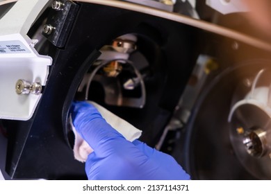 Cleaning Of Ion Source Of Mass Spectrometer By Laboratory Worker In Rubber Gloves. LC MS, Liquid Chromatography And Daily Routine.