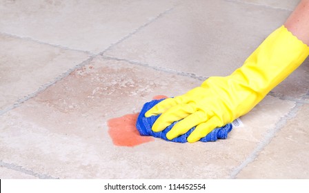 Cleaning Up Juice Spill  On Tile Floor With Cloth