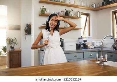 Cleaning, Karaoke And Woman Singing In The Kitchen With A Broom Or Mop Acting Like A Rock Star Singer At Home. Freedom, Music And Happy Cleaner Dancing, Having Fun And Enjoying Radio Audio Or Sound