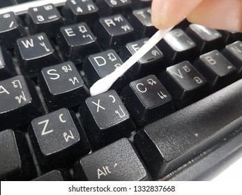 Cleaning Keyboard With Cotton Bud. 