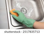 Cleaning kitchen sink with cleaning powder or baking soda