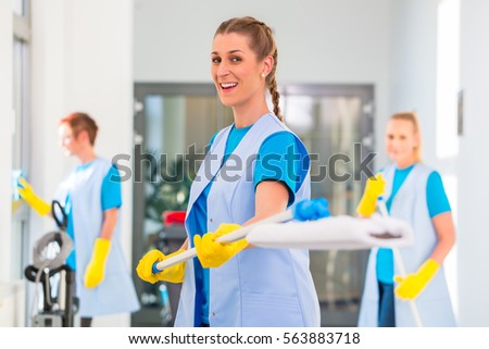 Cleaning ladies team fooling around with mop