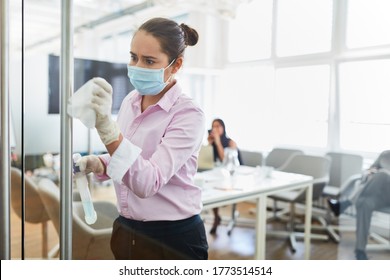 Cleaning Lady With Face Mask Because Of Covid-19 When Disinfecting In The Office With Disinfectant