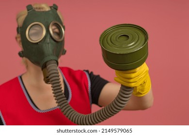 Cleaning Lady In A Gas Mask, Apron And Gloves, Portrait On A Colored Background, Studio Shot