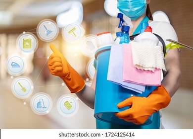 A Cleaning Lady In A Mask Shows The Quality Of Work On A Blurred Background.