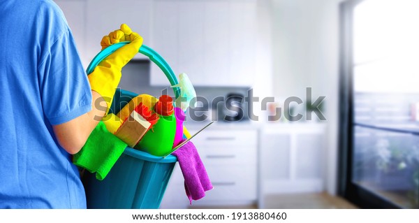 Cleaning lady with set of\
cleaning supplies on blurred background. in bathroom or toilet.\
Woman.