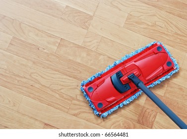 Cleaning Laminate. Red Mop On Hardwood Floors.