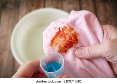 Cleaning Laundry Manually. Women's Hands In Gloves Washing Dirty Stained On Colored Cloth With A Stain Remover And Soak In Soapy Water, Closeup