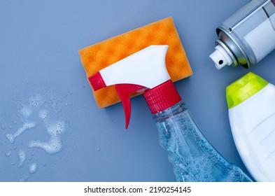 Cleaning Liquid Spray On A Blue Background. Copy Space