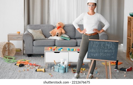 Cleaning, Living Room And Blackboard With A Woman Mother In Her Home To Clean Up Children Toys Off Of The Floor. Mom, Cleaner And Mess With A Strict Female In Messy Lounge With A Helmet And Goggles