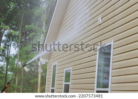 Cleaning maintenance service for washing siding house and maintaining the home a high-pressure spray nozzle with soap cleaner and water