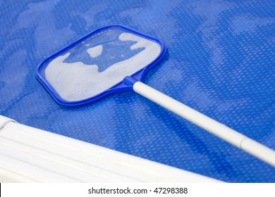 Cleaning Net On A Solar Cover Of A Pool