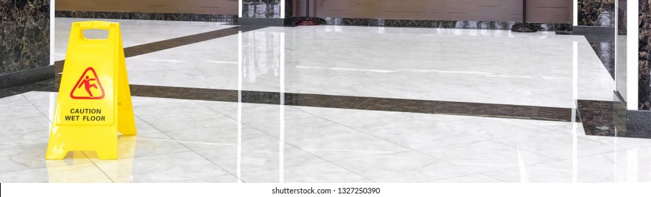 Сommercial Cleaning In Office, Shiny Marble Floor In Luxury Lobby Of Hotel Or Company. Panoramic View Of Washed Cleaned Floor And Sign Of Caution In Hallway. Cleaning Service And Care Concept.