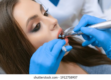 Cleaning And Polishing Tooth Enamel In The Dental Office. Young Girl In The Dental Office.