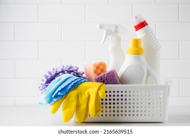  Cleaning products for cleaning, disinfection at home in a basket on a light background.  - Shutterstock ID 2165639515