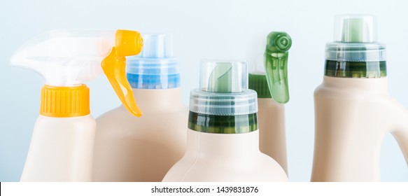 Сlose-up Of Cleaning Products On Blue White Background Overview With Space For Text. Front View. Cleaning Tools Layout.  Blank Mockup Eco Design Of Plastic Bottles Packaging Of Detergent.