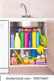 Cleaning Products Placed In Kitchen Cabinet Under Sink. Housekeeping Storage Space