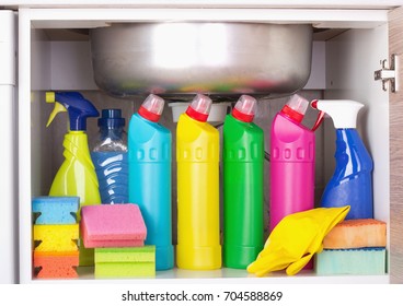 Cleaning Products Placed In Kitchen Cabinet Under Sink. Housekeeping Storage Space