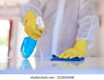 A Cleaning Professional Sprays A Kitchen Counter With Sanitiser