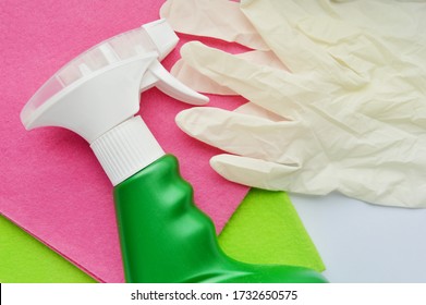 Cleaning rag in various colors, detergent and white rubber gloves on white