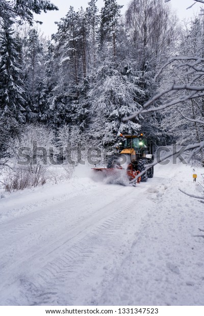 Cleaning the road from the snow. Forest in winter. Real\
is beautiful 