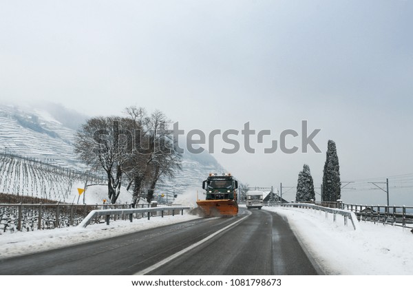 Cleaning of roads from snow.\
Lausanne,\
Switzerland - March 1, 2018.\
Spring snow landscapes along the\
motorways and in the cities of\
Europe.