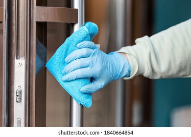 Cleaning and sanitizing  door entrance from bacteria and virus.  Infection prevention and control at public places during epidemic.  Antiseptic, Hygiene and Healthcare concept,  Covid-19 second wave. - Shutterstock ID 1840664854