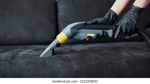 Cleaning Service Company Employee Removing Dirt From Furniture In Flat With Professional Equipment. Female Housekeeper Arm Cleaning Sofa With Washing Vacuum Cleaner Close Up