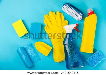 Cleaning service concept.Home cleaning product on a blue background. Bucket with household chemicals. cleaning supplies for home or office space.Early spring regular cleaning. Copy space