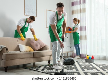 Cleaning Service Team At Work In Living Room