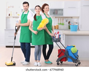 Cleaning Service Team Working In Kitchen