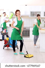 Cleaning Service Team Working In Kitchen